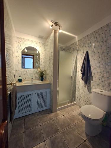 a bathroom with a toilet and a sink and a shower at APARTAMENTO SOL PLAYA in Punta Mujeres