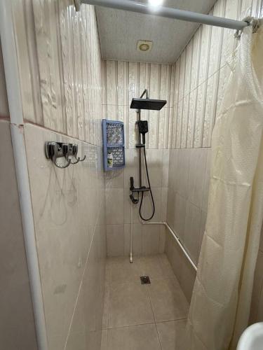 a bathroom with a shower with a shower curtain at Hayrapetyan Apartment Goris in Goris