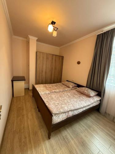 a bedroom with a large bed and a window at Hayrapetyan Apartment Goris in Goris