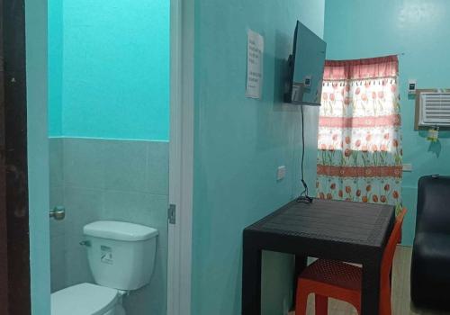 a small bathroom with a toilet and a table at Monique Beach Resort by Hiverooms in Carmen