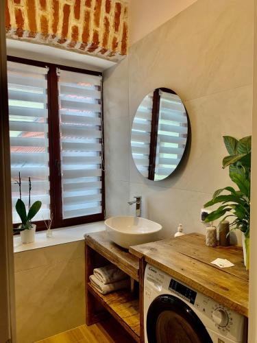 a bathroom with a washing machine and a sink at Apartamenty Magdalena in Lublin