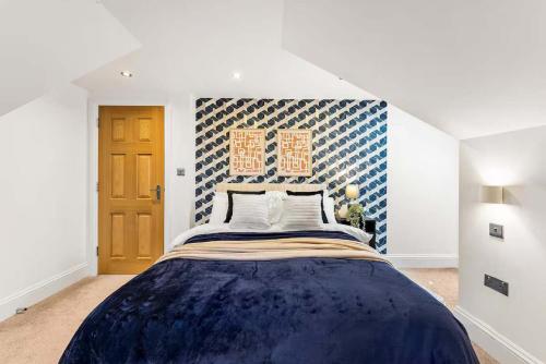 a bedroom with a large bed with a blue blanket at Seafront Duplex Worthing Beach - Sea Views 8 Guests in Worthing