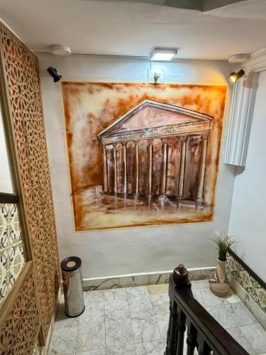a painting on the wall of a room with at Hotel Roma in Tunis