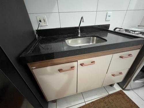 a kitchen with a sink and a counter at Excellent value for money - Fully equipped apartment in Macaé