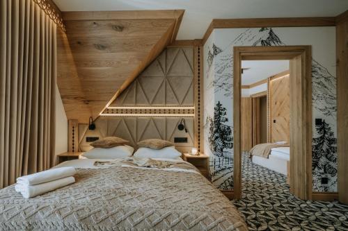 a bedroom with a large bed and a large mirror at Willa Regina I Resort & SPA in Zakopane