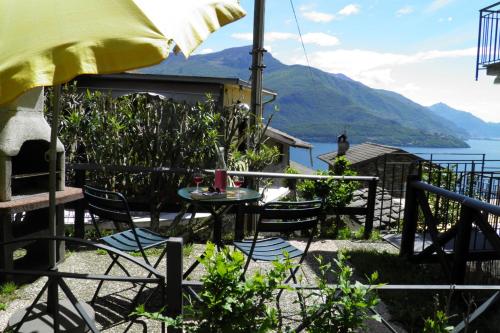 a table and chairs with a view of the water at Amarone Classica in Gravedona