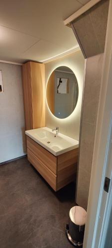 a bathroom with a sink and a mirror at Apartment Solbakken Feriehus in Fevåg