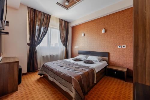 a hotel room with a bed and a window at INTER BUSINESS Bucharest in Bucharest