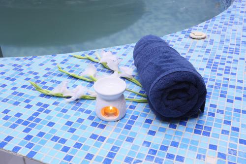 a roll of blue towels on a table at Avari Towers Karachi in Karachi