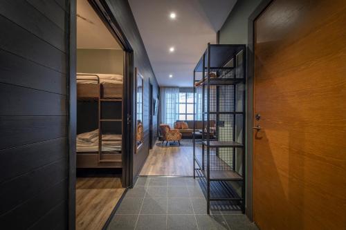 a hallway with a staircase leading to a room with bunk beds at Skistar Lodge Lindvallen in Sälen