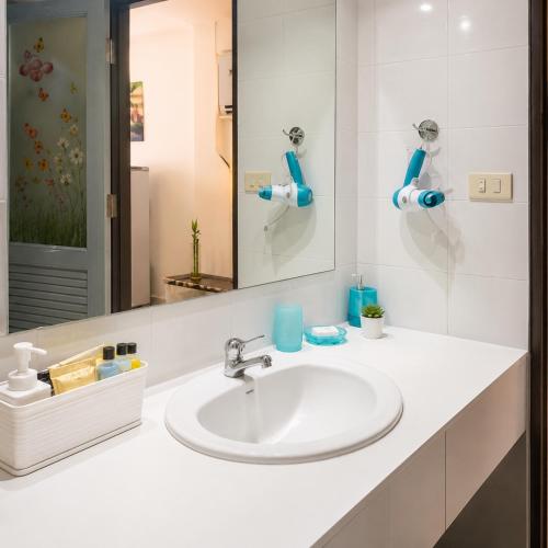 a bathroom with a sink and a mirror at View Talay 1B Holidays in Pattaya South