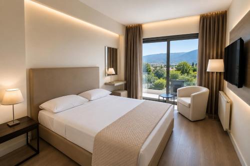 a hotel room with a bed and a large window at Droushia Heights Hotel in Drousha