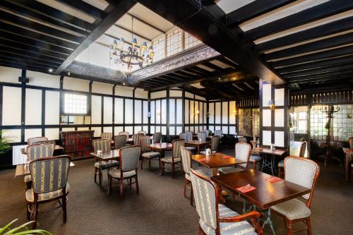 a dining room with tables and chairs and a chandelier at Best Western Red Lion Hotel in Salisbury