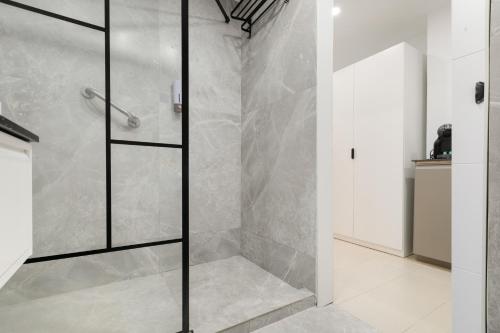 a shower with a glass door in a bathroom at Infinity Summer in San Miguel de Abona