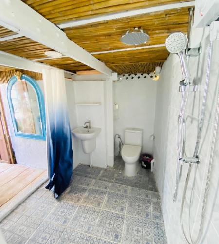 a bathroom with a toilet and a shower and a sink at The Boathouse in Bang Sare