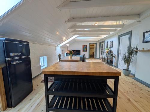 a kitchen with a large island in a room at Sigurd's Loft in Vossevangen