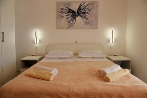 a bedroom with a bed with two towels on it at Dalmatino 3 Rukavac Vis in Rukavac