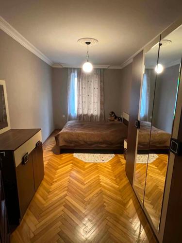 a bedroom with two beds and a table and a mirror at there is no a name in Itʼkhvisi
