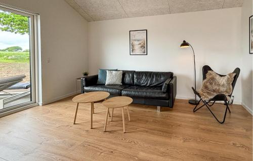 a living room with a couch and a table and chairs at 4 Bedroom Cozy Home In Haderslev in Haderslev