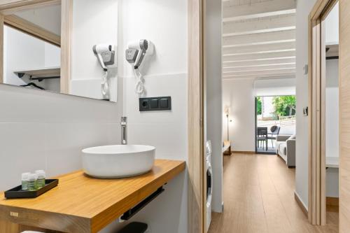 a bathroom with a sink on a wooden counter at Apartamentos el Caneyón in San Juan de Parres