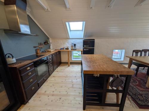 a large kitchen with a table and a window at Sigurd's Loft in Vossevangen