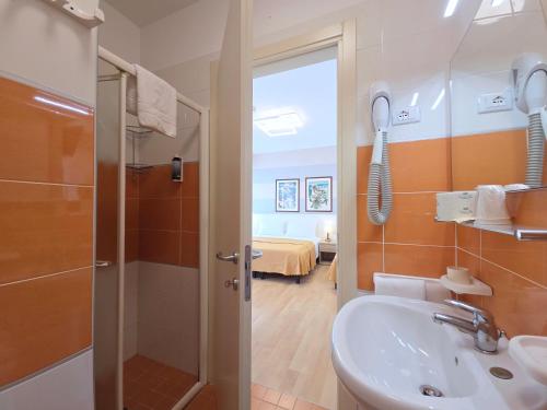 a bathroom with a sink and a shower and a sink at Hotel Parigi in Caorle