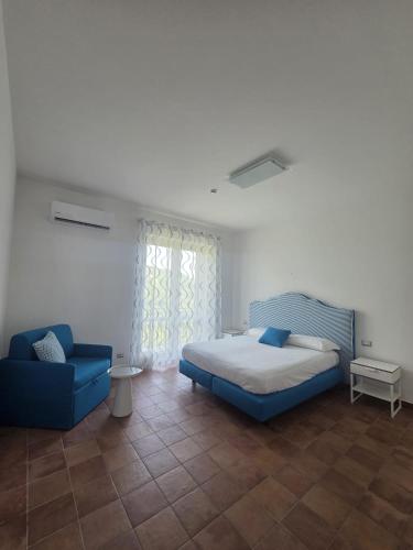 a bedroom with a blue bed and a blue chair at Ravello Sky & Sea in Ravello