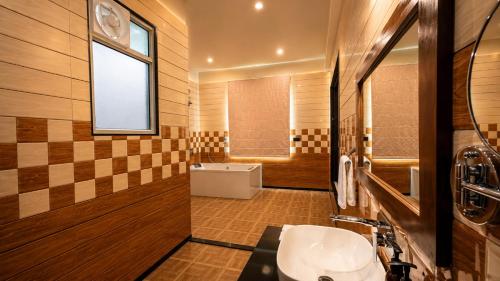 a bathroom with a sink and a tub and a window at Roop Garh Palace, Jaipur in Jaipur