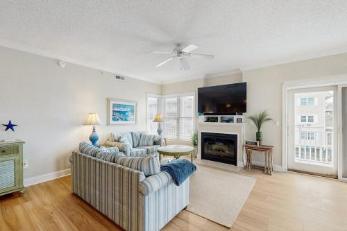 a living room with two couches and a fireplace at Condo 4100 #201 in Ocean City