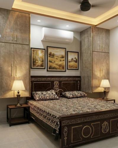 a bedroom with a bed with two pillows on it at Shabbir Premier Heights in Lahore