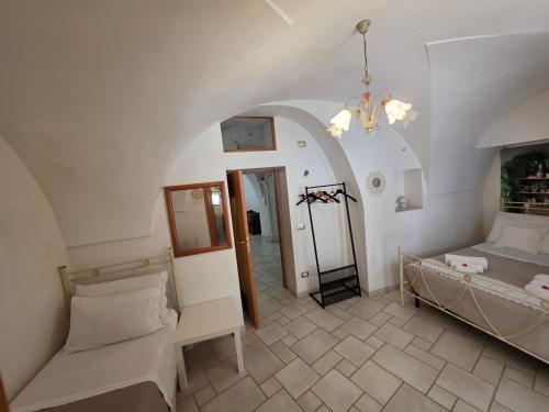 a bedroom with a bed and a mirror in a room at Nonno Pasquale house in Locorotondo
