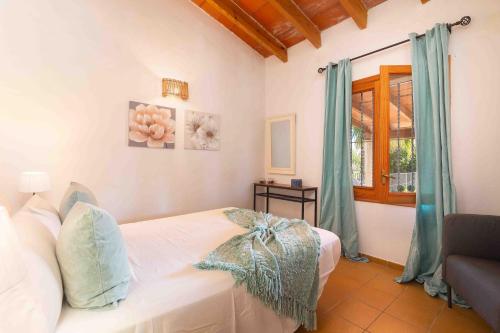 a bedroom with a white bed and a window at Can gallu in Moscari