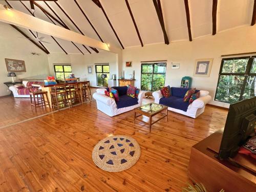 a living room with two couches and a table at Kangela 14 in Ponta Malangane