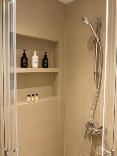 a shower with a glass door in a bathroom at Soho Residence سوهو ريزيدنس in Kuwait