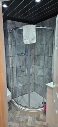 a shower with a glass door in a bathroom at The Trafford Hotel in Blackpool