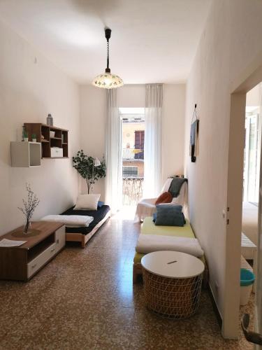 a living room with two beds and a table at La Cà De Zan in Mezzegra
