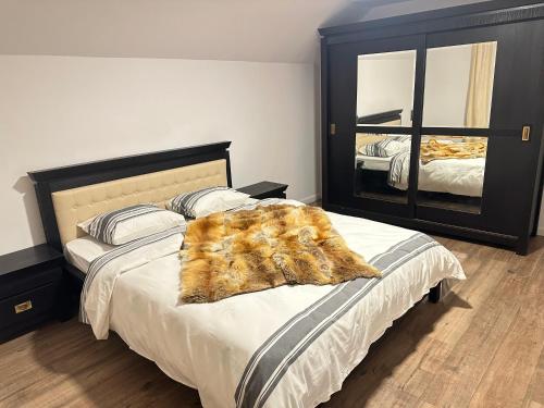 a bedroom with a bed with a fur blanket on it at Casa Horeb Apuseni in Sohodol