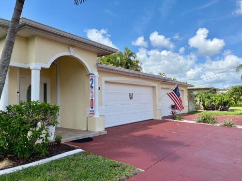 a house with an american flag in front of it at Villagoona in Cape Coral