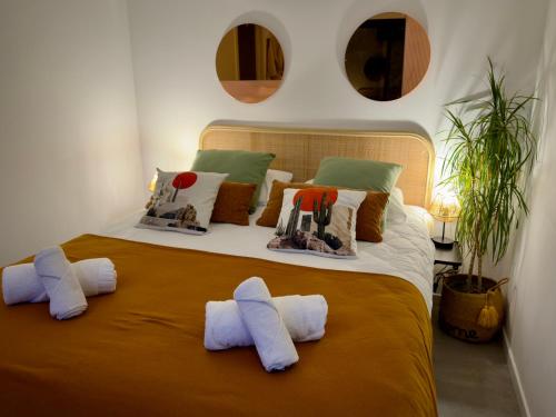 a bedroom with a large bed with pillows on it at Maison des Chênes 64 - Spa Lodge in Boucau
