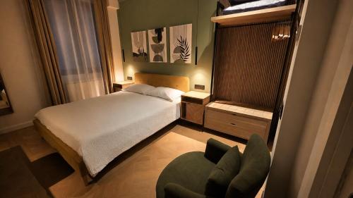 a small bedroom with a bed and a chair at Centro & Mare - Rooms - Garage - Suites in Termoli
