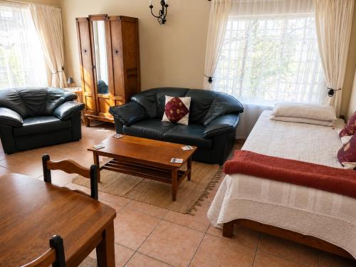 a living room with a couch and a coffee table at Alpha Self-Catering in Sutherland