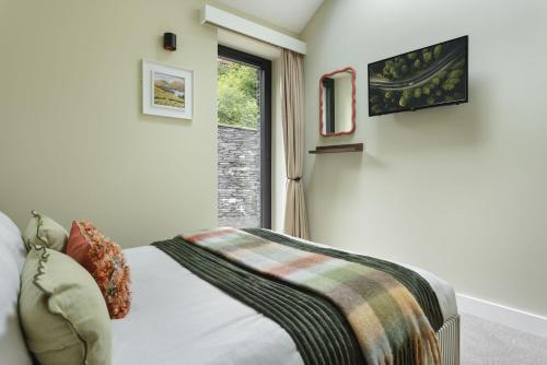 a bedroom with a bed and a window at Fawns Keep - Ridgestone in Bowland Bridge