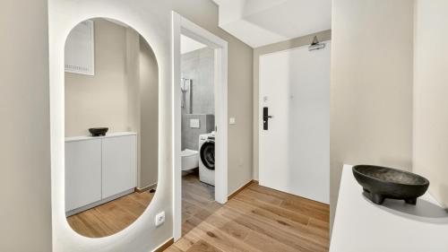 a bathroom with a mirror and a black sink at Smile Apartments in Povljana