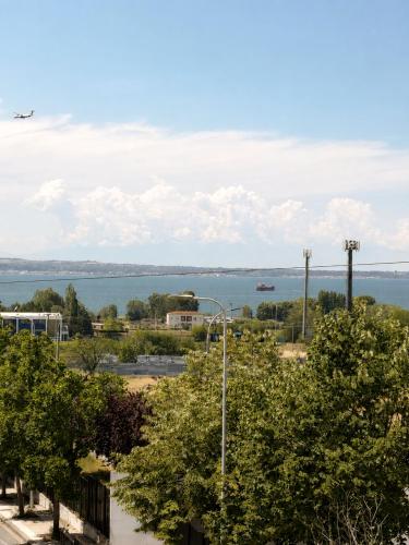 an airplane flies over a parking lot with a view of the water at Blue Horizon SKG in Thessaloniki