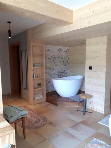 a bathroom with a large white tub in a room at Le chalet du Chardonneret in Soultzbach-les-Bains