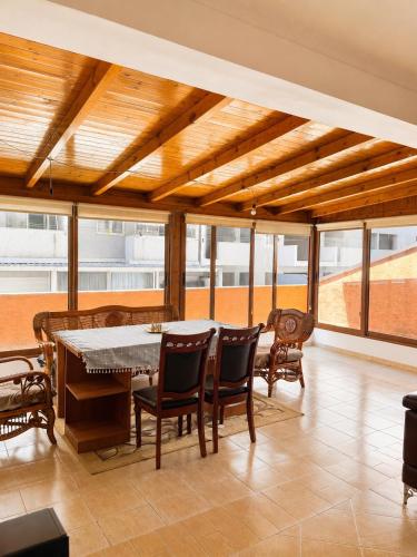 a dining room with a table and chairs at Terminal Comfort Apartament in Tirana