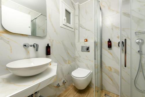 a bathroom with a sink and a shower at Sunny Hotel Thassos in Chrysi Ammoudia
