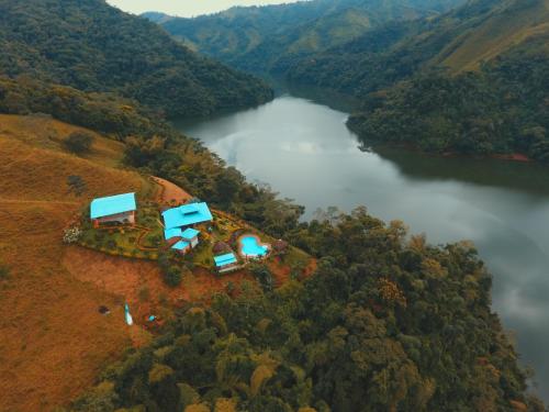 an aerial view of a house on a hill next to a river at Ecohotel Campo Alegre Norcasia Caldas in Norcasia