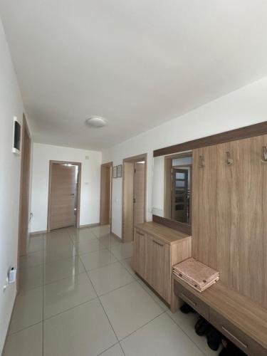 a large room with wooden cabinets and a hallway at Slavuj in Novi Sad