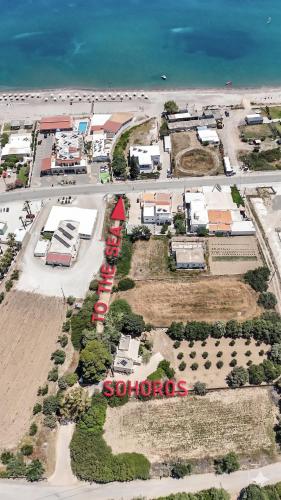 an aerial view of a town with a train on the beach at Hamilton - Sohoros in Kámpos